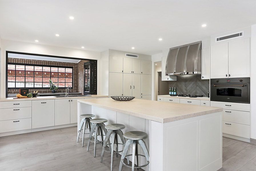 Kitchen with stone island bench and stools