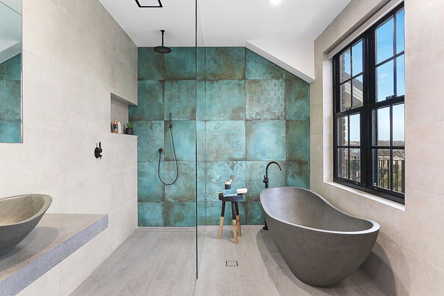 Bathroom with teal feature tiles and stone bath