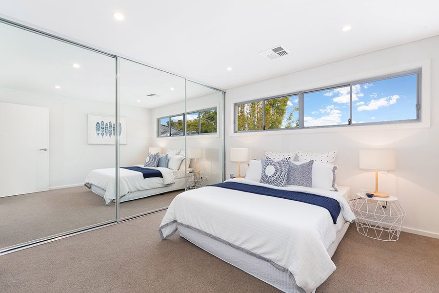 Bedroom with mirrored wardrobe